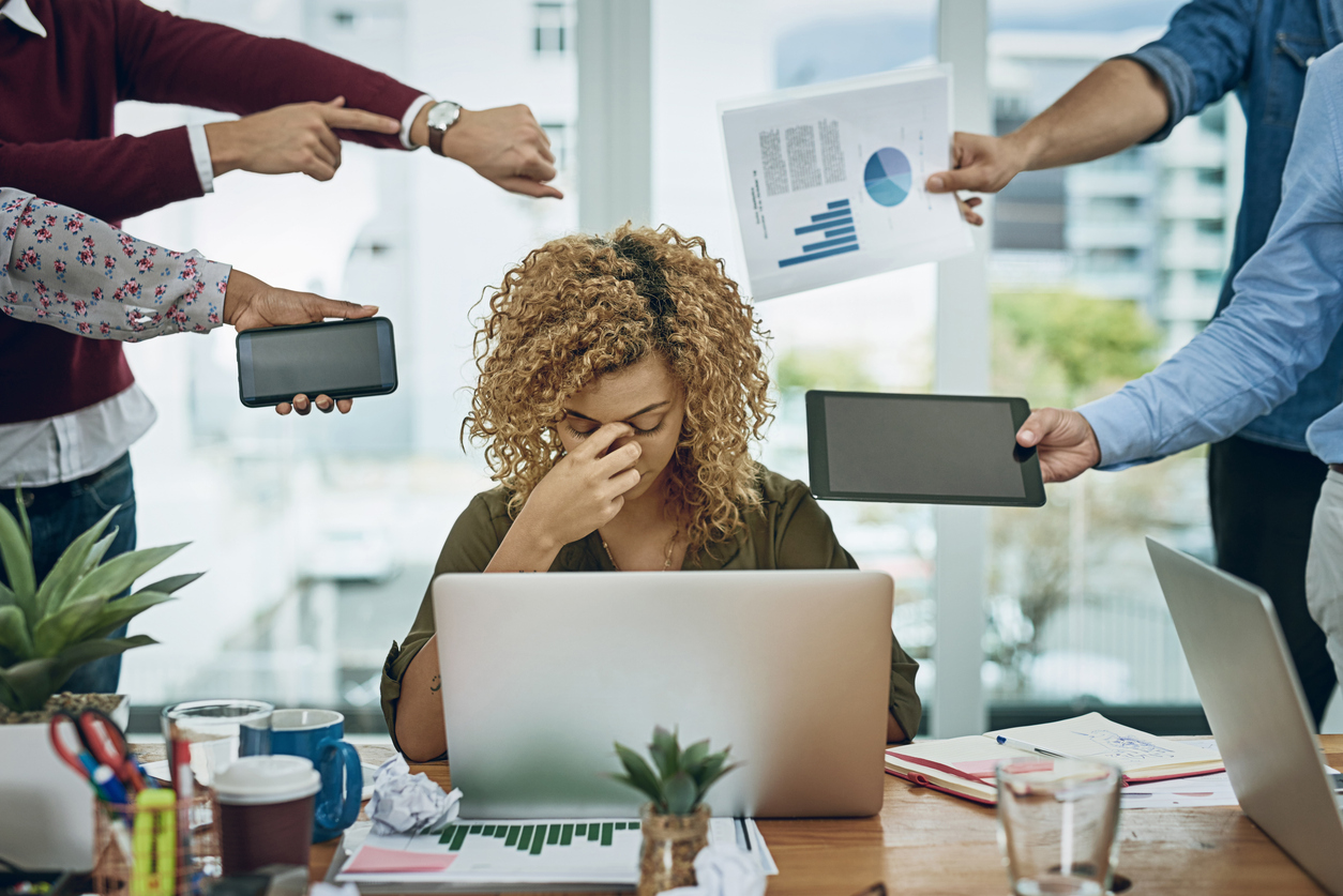 Frustrated B2B marketing leader reviewing reports at her desk with AI and analytics icons in the background, illustrating five warning signs it’s time to switch digital marketing agencies in 2026.